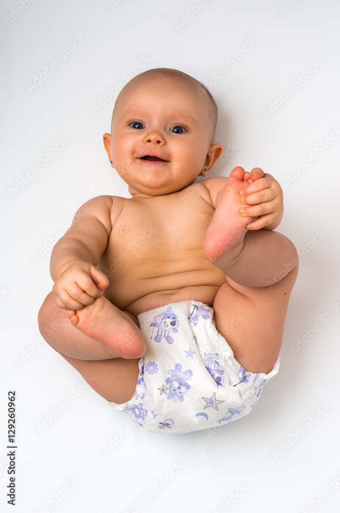 Adorable baby girl lying on back - isolated on white