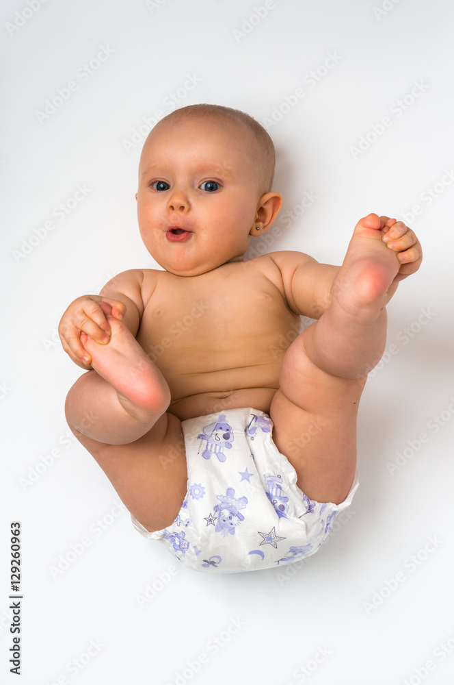Cute baby in diaper lying on back - isolated on white
