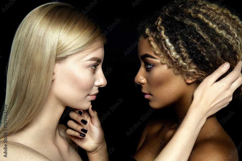 Tolerance. Half faces of two girls. Black and white. Tolerance. Half faces of two girls. Black and white.