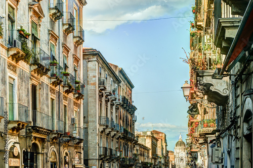 Catania arhitecture - Street view with facades of residential houses, lanterns and roofs in warm sunset light. Catania, Sicily, Italy. © romas_ph