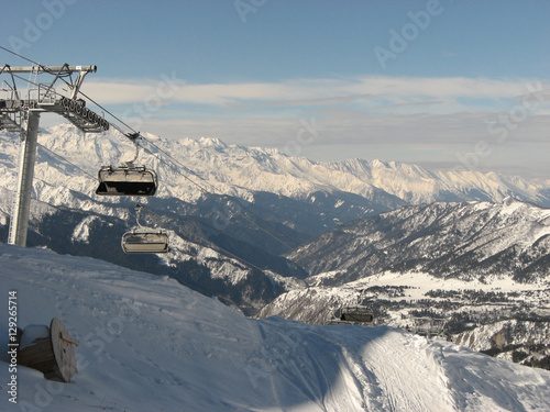 Skilift against background of landscape of the Caucasus Mountains on sunny winter day, Tetnuldi, region Svaneti in Georgia.