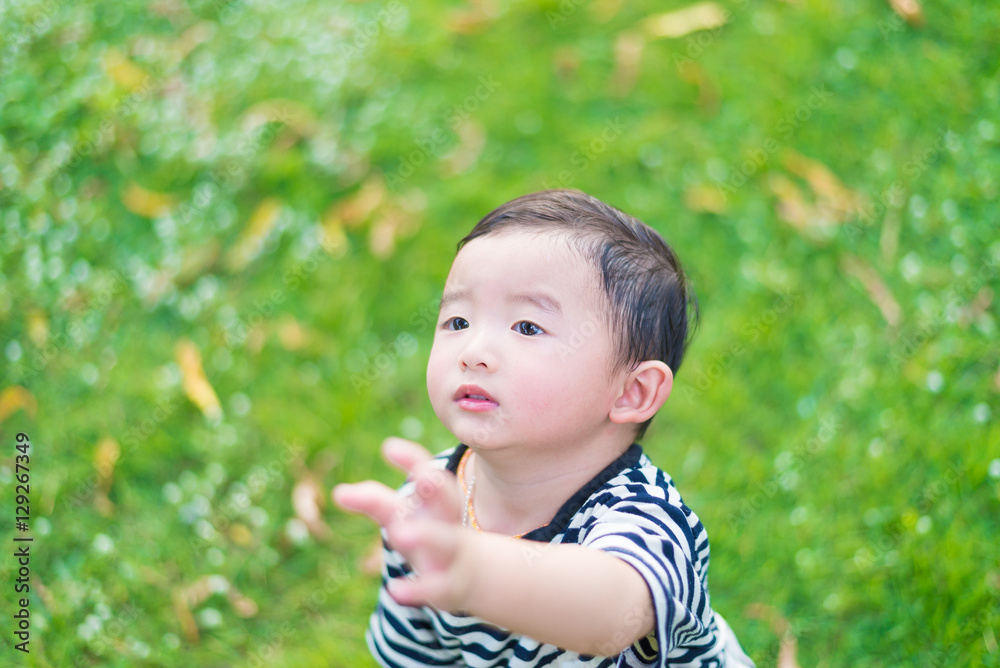 Close-up little Asian boy looking up somewhere and thinking with Close-up little Asian boy looking up somewhere and thinking with