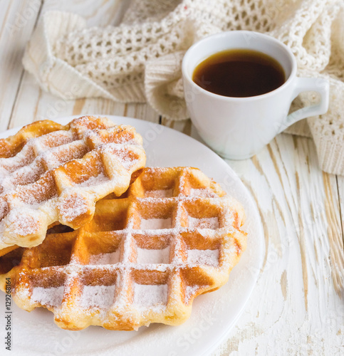 Warm knitted plaid, cup of coffee and Belgium waffles