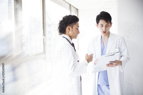 Two young male doctors are talking