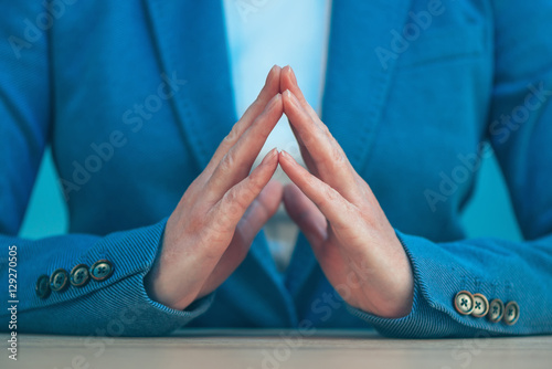 Steepled fingers of business woman as hand gesture confident sig