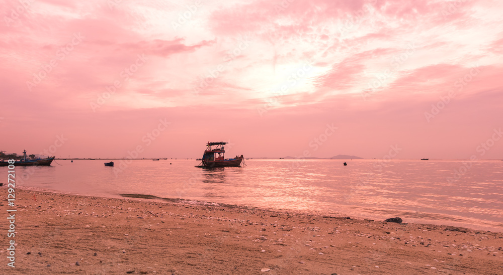 Fishermen Boat sailing in the sea with a beautiful set sunset behind