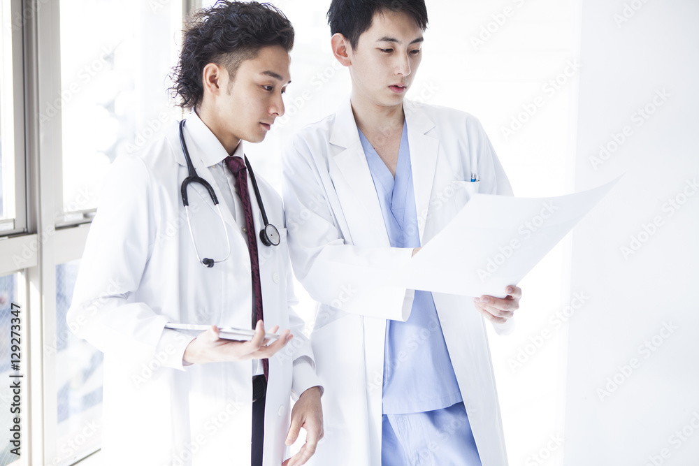 Doctors are talking while watching a medical record Doctors are talking while watching a medical record