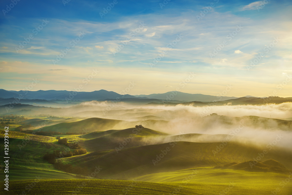 Volterra foggy panorama, rolling hills and fields Tuscany Italy.
