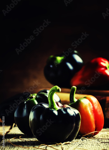 Black bell pepper, vintage wooden background, selective focus