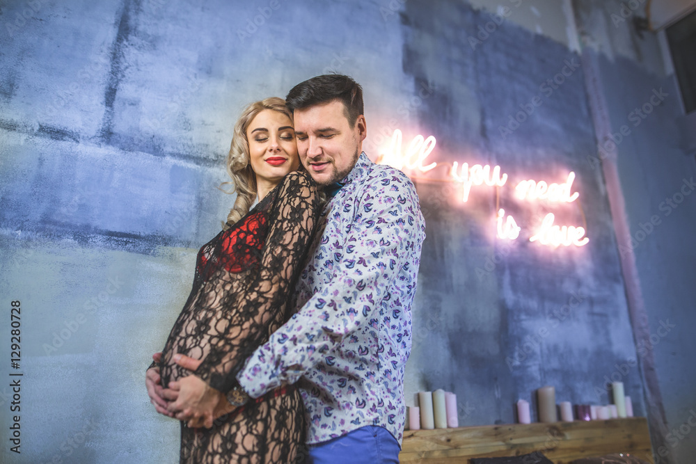a young couple. Love concept. Man hugging pregnant woman a young couple. Love concept. Man hugging pregnant woman