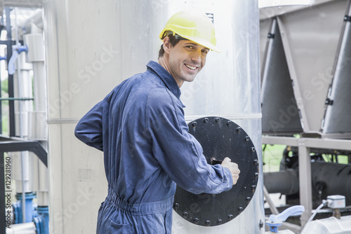 Skilled worker operating incinerator in power generation plant photo