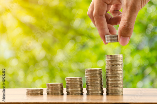 Hand putting money from growing