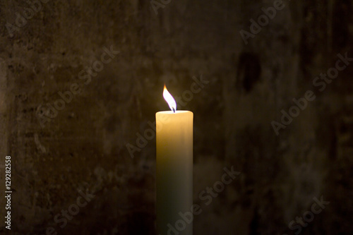 Burning candles in a large Gothic Church. Candles in a dark Church 