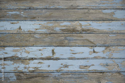 A full page of distressed floor boards background texture with flaking blue paint