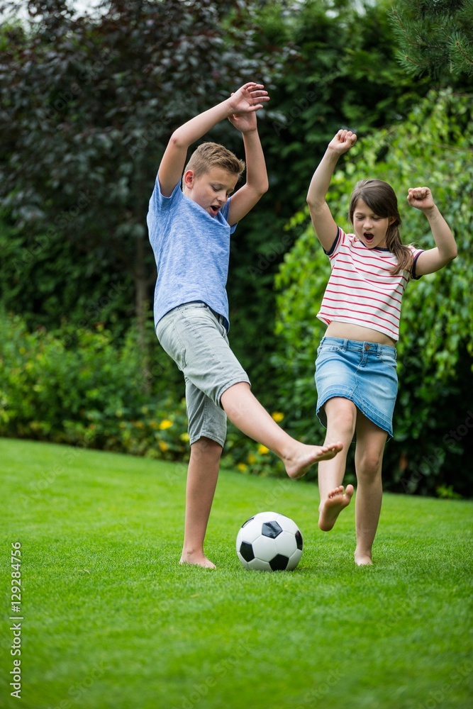 Kids playing with football in park