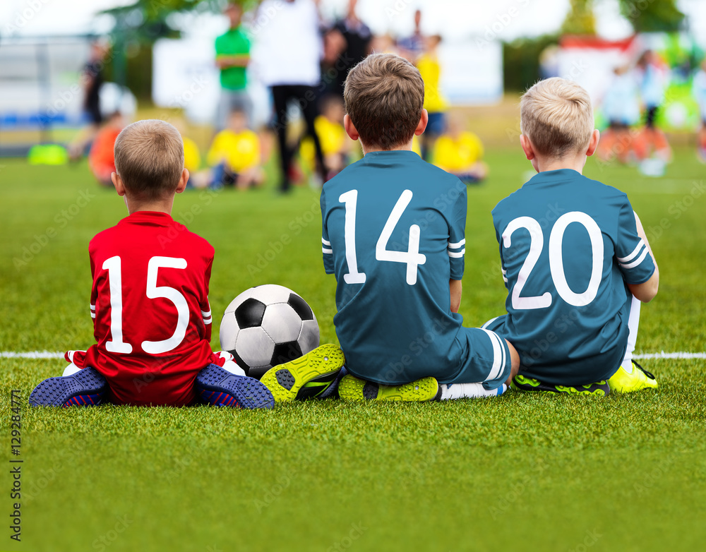 Football Game for Kids. Young Boys Soccer Players Athletes. Children Football Players at Match with Ball. Soccer Bench of Youth Team. Footballers in Red and Blue Sportswear Football Game for Kids. Young Boys Soccer Players Athletes. Children Football Players at Match with Ball. Soccer Bench of Youth Team. Footballers in Red and Blue Sportswear