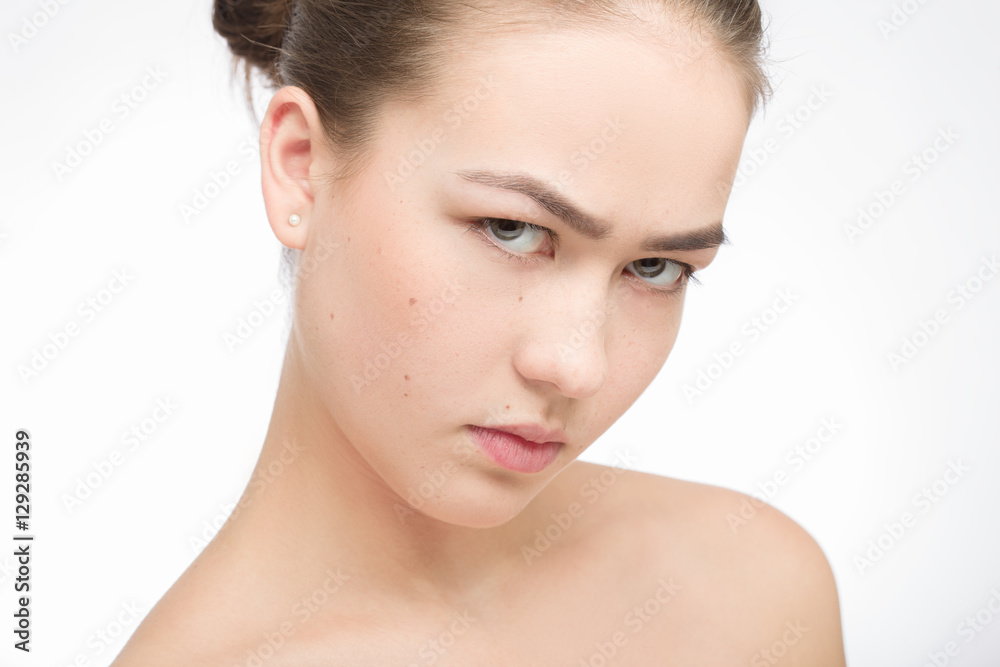 angry beautiful girl looking at camera on white background