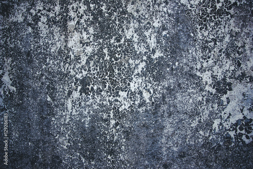 Grunge dirty cracked concrete wall with peeling paint background.