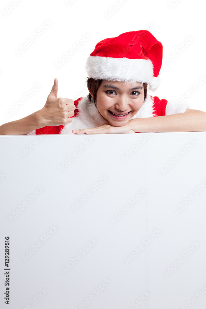 Asian Christmas Santa Claus girl thumbs up with blank sign.