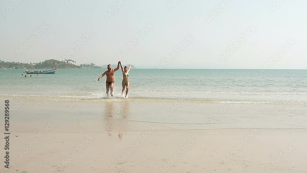 Happy man and woman swimming on the beach Happy man and woman swimming on the beach