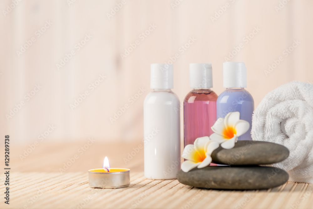 burning candle and beauty products for massage and spa treatment