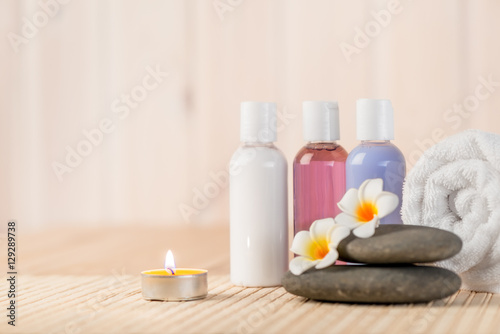 burning candle and beauty products for massage and spa treatment