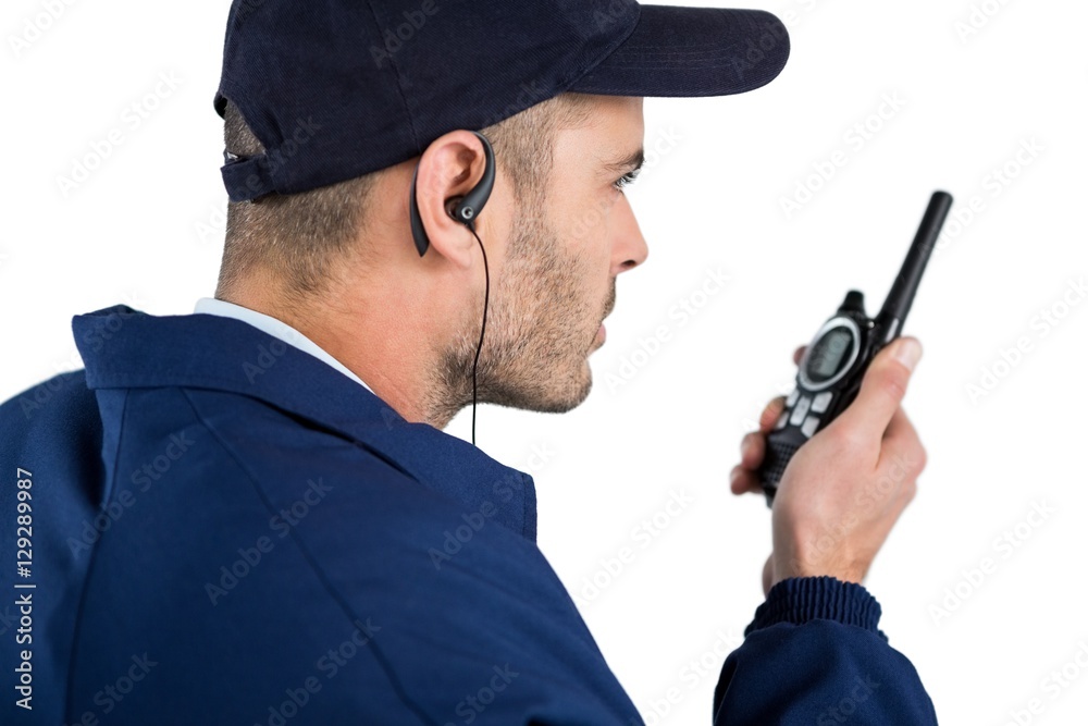 Close-up of security officer talking on walkie-talkie Close-up of security officer talking on walkie-talkie