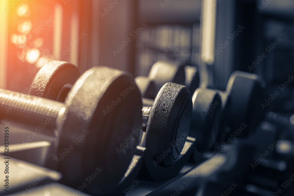 Fototapeta premium Rows of dumbbells in the gym with hign contrast and monochrome c