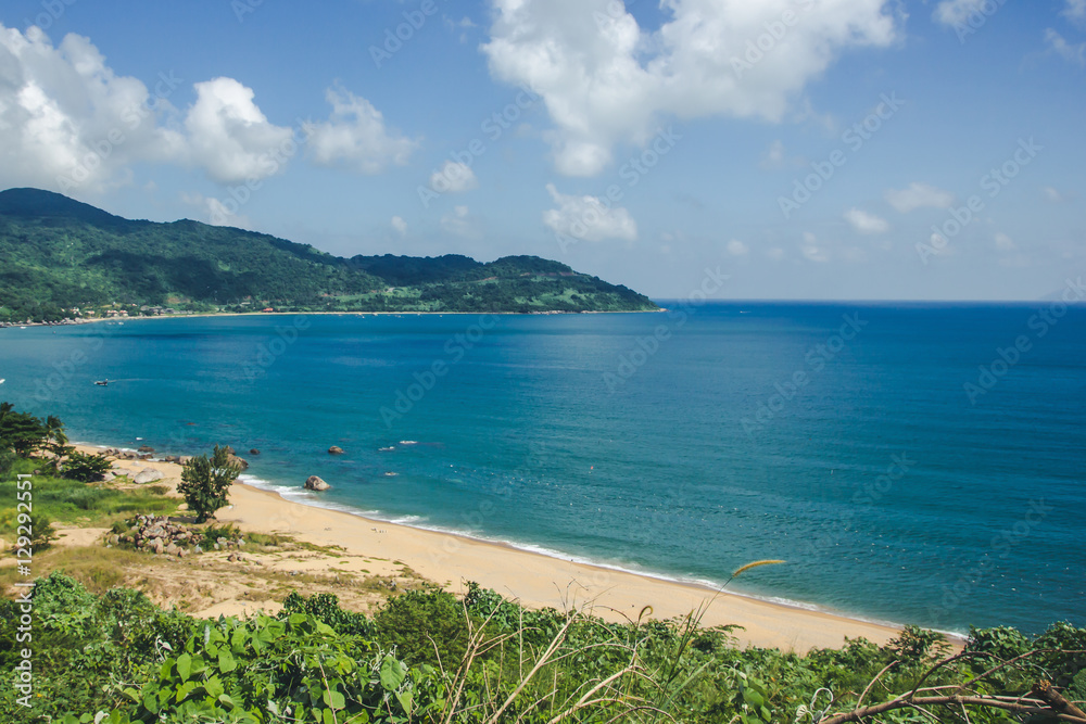 Sea shore with sandy beach and blue sky. Vacation in Vietnam landscape.
