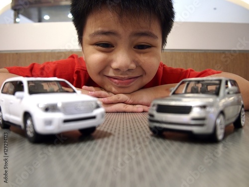 Young boy looking at toy cars