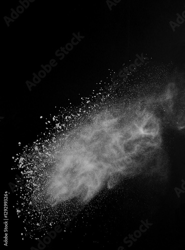 White powder exploding isolated on black