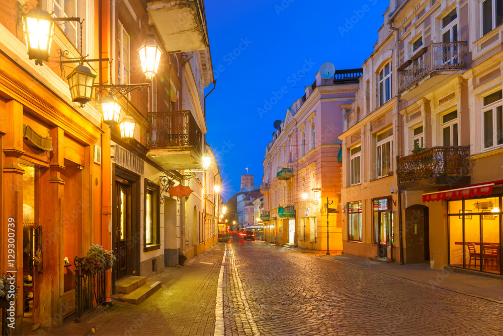 Gediminas Tower or Upper Castle as viewed from Pilies Street with luminous track from the car at night, Old Town of Vilnius, Lithuania, Baltic states.