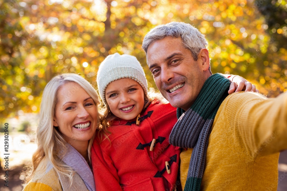 Portrait of smiling family against trees Portrait of smiling family against trees