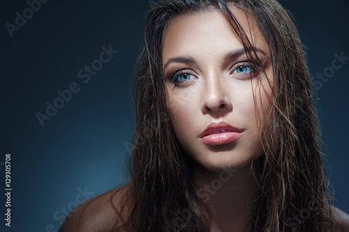 Sexy beauty. Close-up studio portrait of young fashion model with beautiful blue eyes looking away.