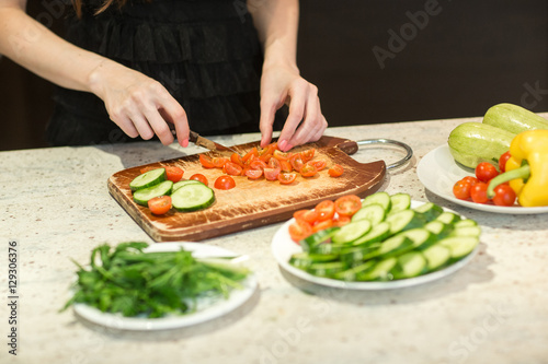 Fototapeta Naklejka Na Ścianę i Meble -  Woman's hands cutting vegetables.