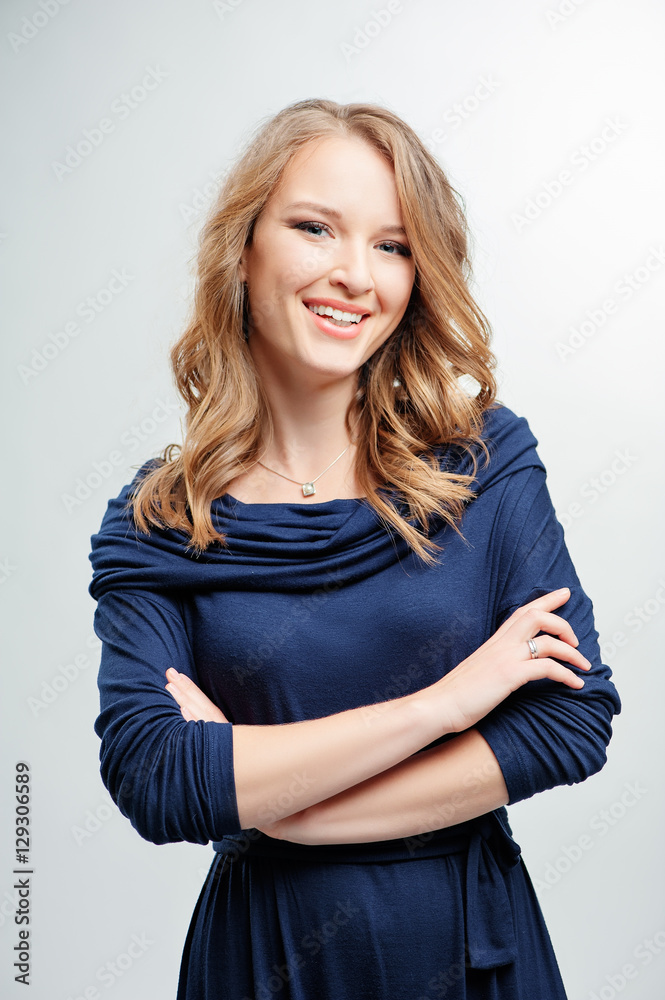 Confident beauty. Studio portrait of pretty yong woman with folded hands. White background. Confident beauty. Studio portrait of pretty yong woman with folded hands. White background.