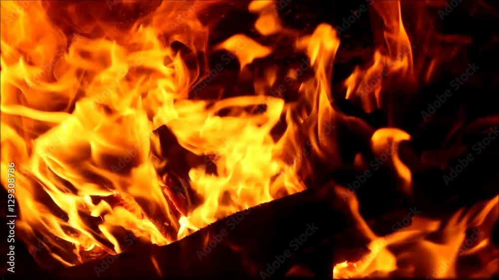 Burning fire with wood and legs in fireplace Burning fire with wood and legs in fireplace