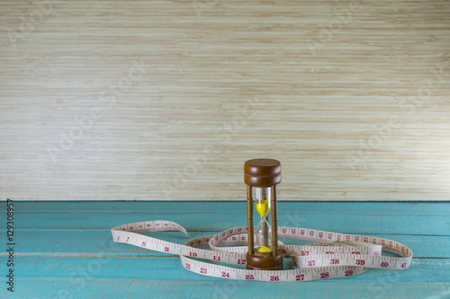 Hourglass with the tape measure shows the weight control.it take