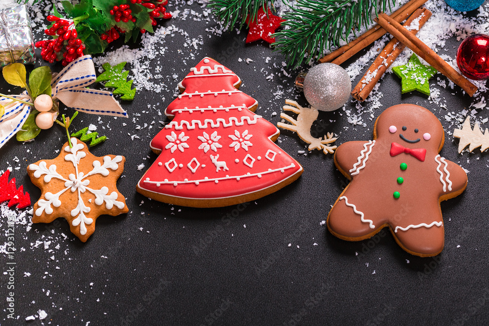Christmas cookies with candy, cone and fir festive decoration with snow. View with copy space