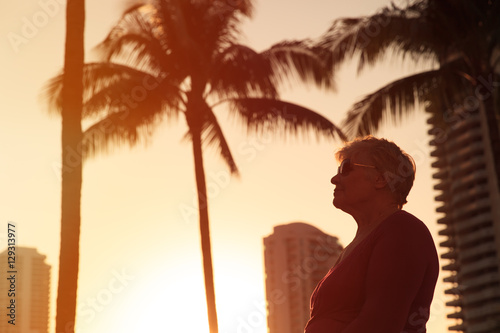 happy senior woman at sunset tropical beach © nadezhda1906