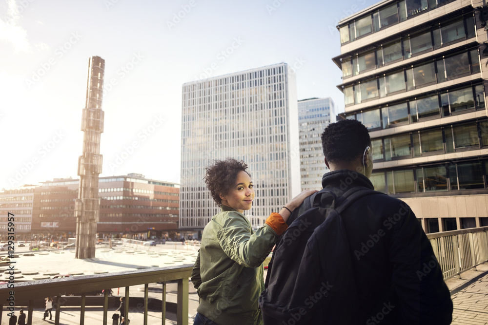 Portrait of teenage girl walking with friend on bridge in city Portrait of teenage girl walking with friend on bridge in city