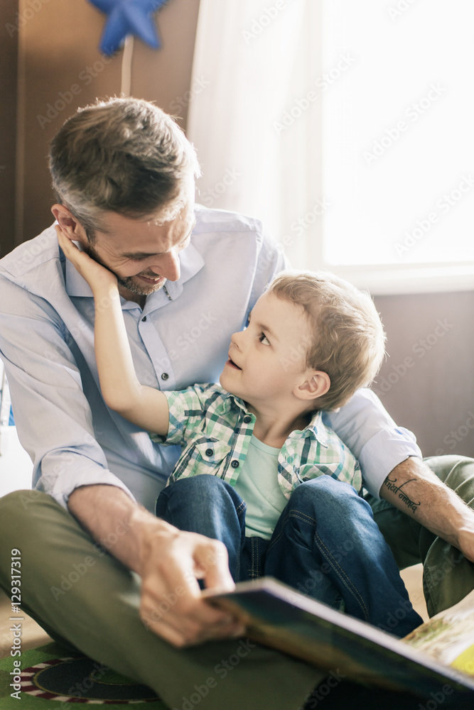Father reading book with son Father reading book with son