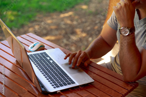 Man working on laptop.Man working while on vacation.