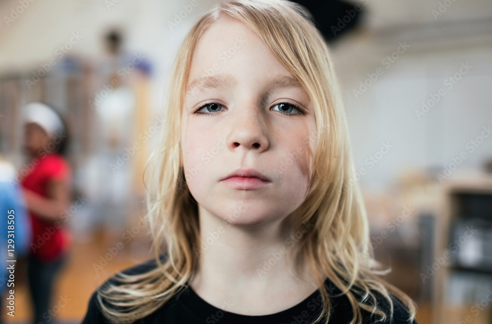 Portrait of girl with blonde hair standing in school Portrait of girl with blonde hair standing in school