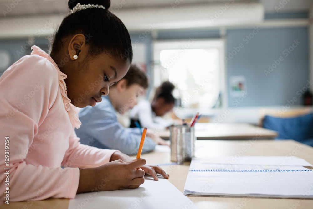 Concentrated students studying at desk in classroom Concentrated students studying at desk in classroom
