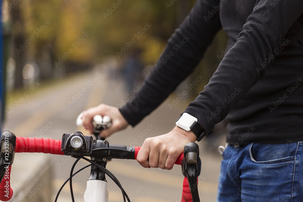 Man with his bike preparing to ride, with park in background and Man with his bike preparing to ride, with park in background and