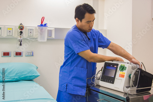 doctor check EKG monitor before use with patient