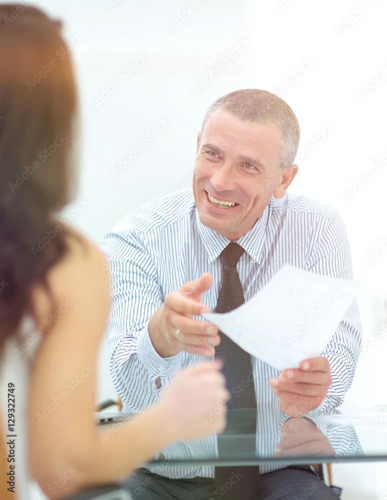 boss discusses with the assistant business documents in the offi