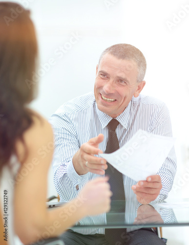 boss discusses with the assistant business documents in the offi