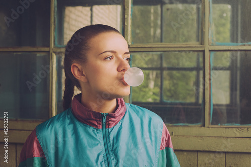 The girl in the nineties inflates chewing bubble